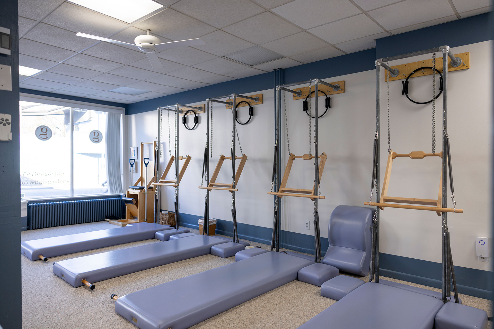 Group Pilates tower class at Studio G Pilates in East Northport, NY for stress and anxiety relief.